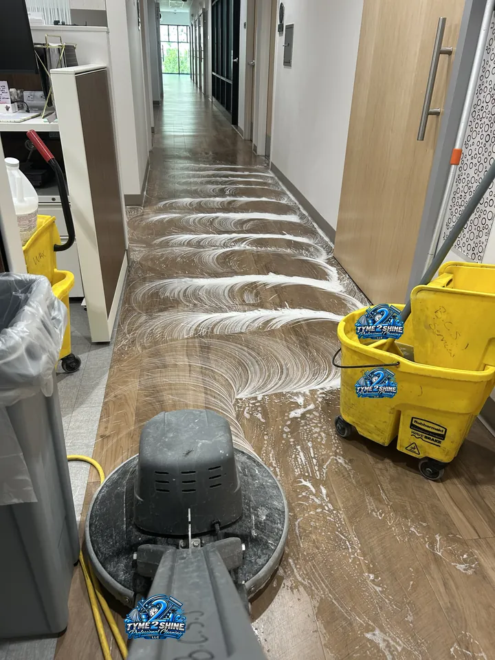 Floor machine scrubbing a medical office hallway
