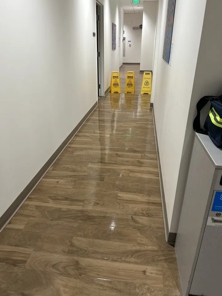 Shining floors in a long office corridor