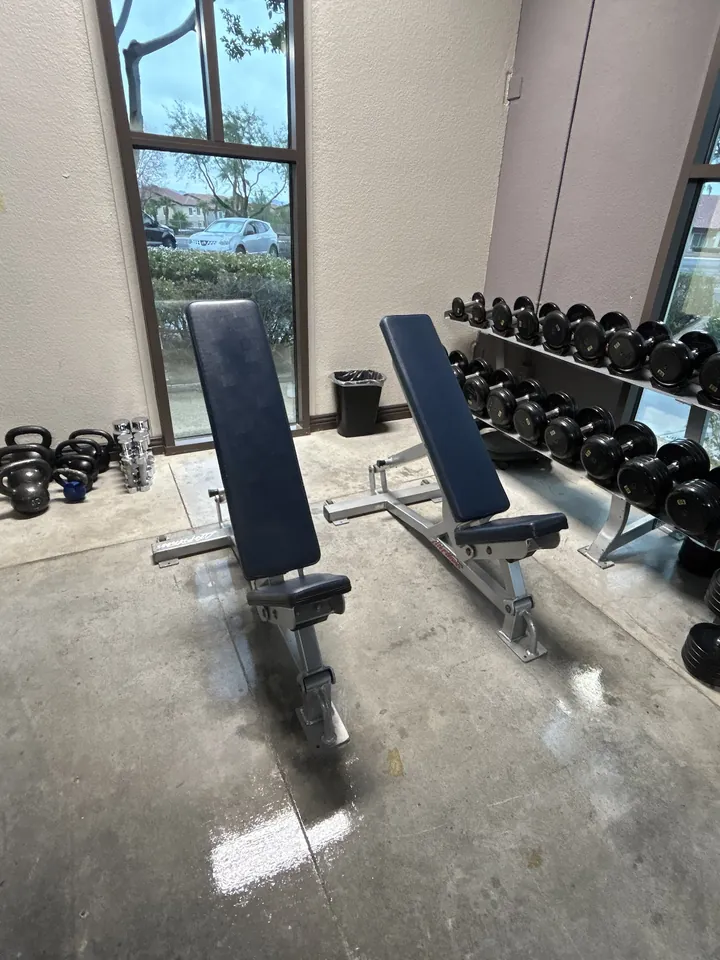 Clean gym floor around weight benches